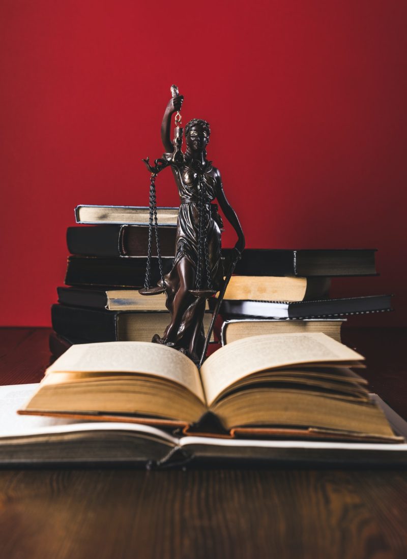 opened-juridical-books-with-lady-justice-statue-on-wooden-table-law-concept-1.jpg